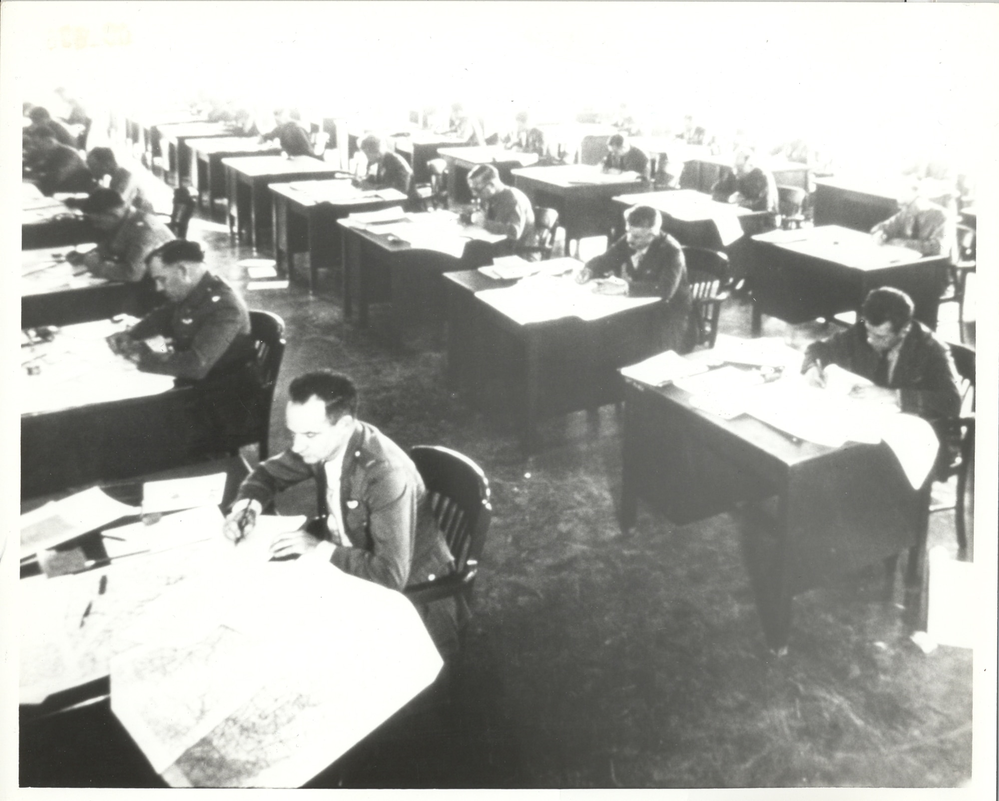In this historical image, officers take part in a map reading exercise in the 1930s at the Air Corps Tactical School, Maxwell Field, Alabama. The school moved from Langley Field, Virginia, to Maxwell Field in 1931. With its first class starting on Nov. 1, 1920, at Langley Field, it was first called the Air Service Field Officers School then Air Service Tactical School before being renamed Air Corps Tactical School in 1926, five years before its move to Maxwell. (Courtesy photo)
