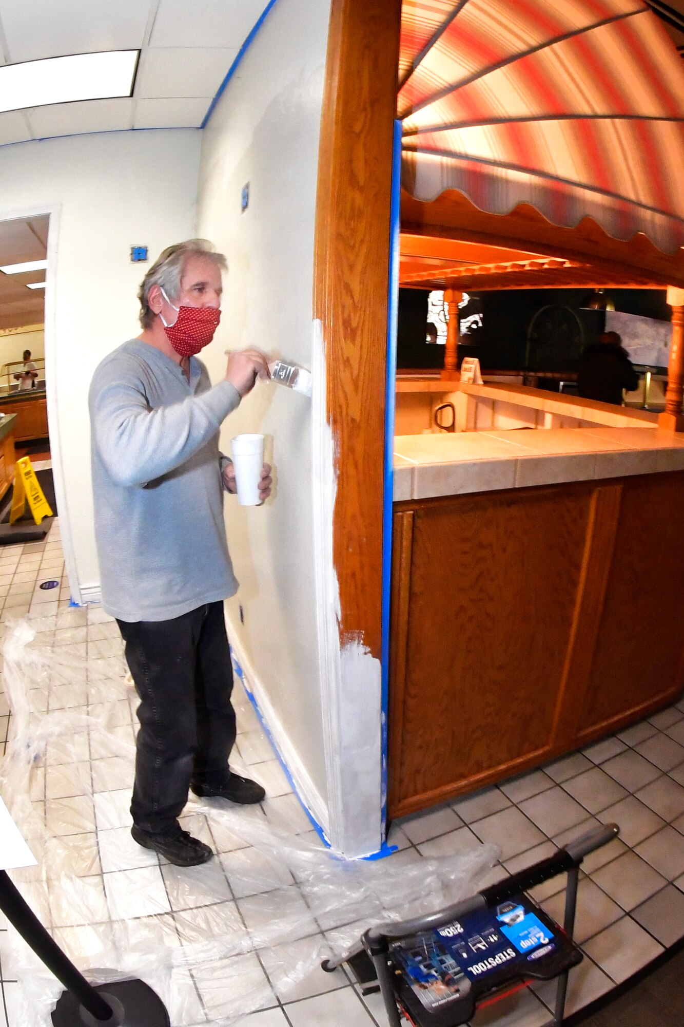 Eric Smith, 75th Force Support Squadron food service specialist, paints the interior of a dining facility Oct. 27, 2020, during a self-help renovation project on Hill Air Force Base, Utah. The DFAC facelift work is being accomplished by food service staff and many volunteer Airman from various squadrons across the base. (U.S. Air Force photo by Todd Cromar)