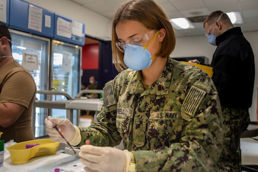 A female sailor handles a blood test.