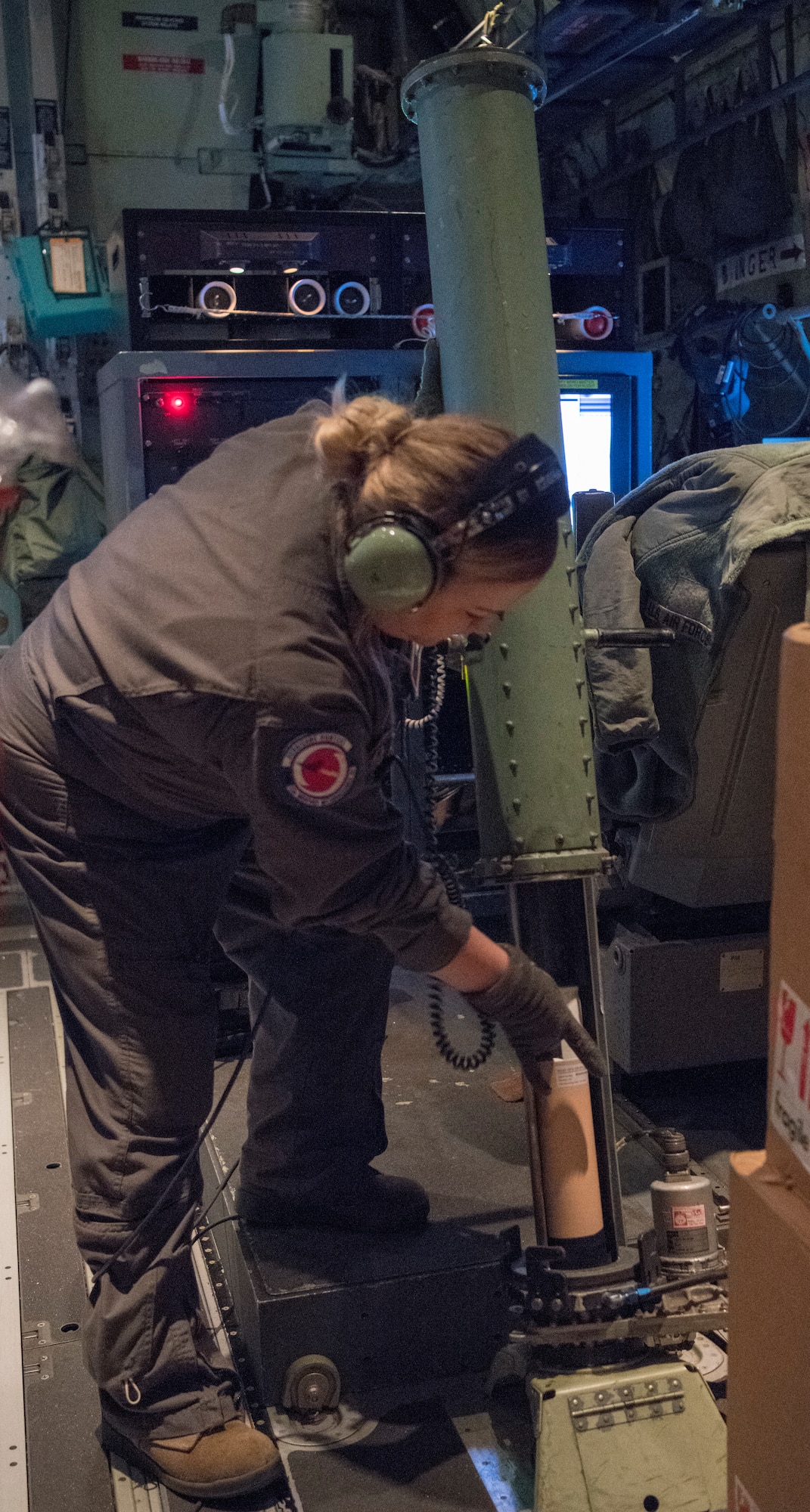 Tech. Sgt. Jenna Hemphill, loadmaster for the 53rd Weather Reconnaissance Squadron at Keesler Air Force Base, prepares a dropsonde for release during a flight into Hurricane Eta Nov. 3, 2020. The dropsonde is released into the atmosphere of a tropical system to record wind speed, barometric pressure temperature and other data satellites cannot, and the information is sent to the National Hurricane Center for forecasting models. (U.S. Air Force photo by Senior Airman Kristen Pittman)