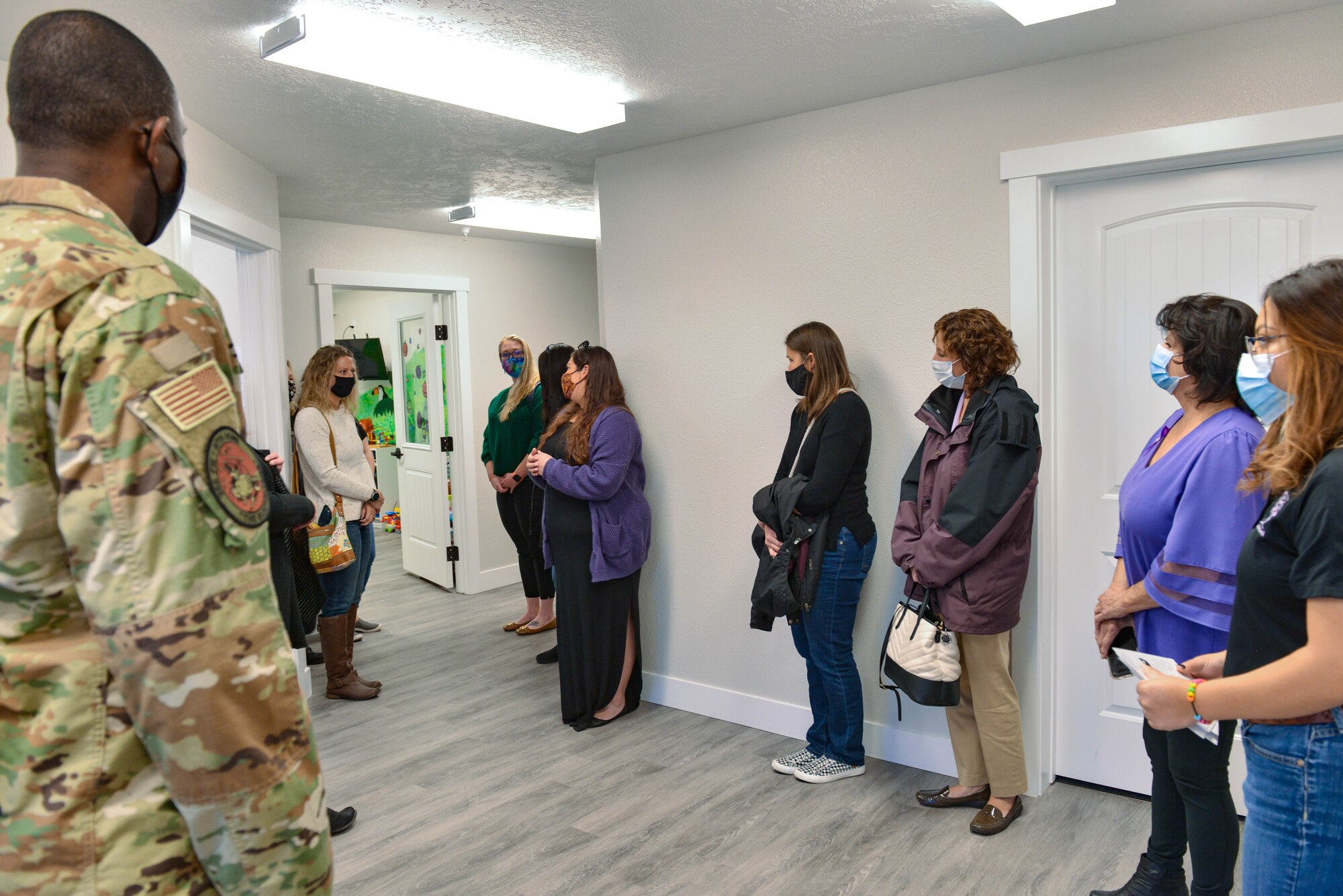 A group of people stand together in a room.