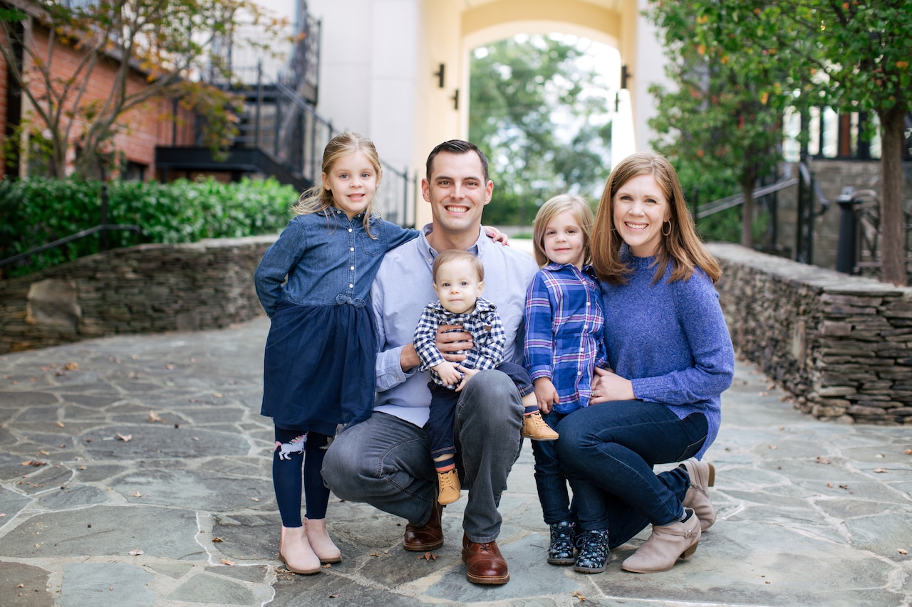 A family of five pose for a photograph.