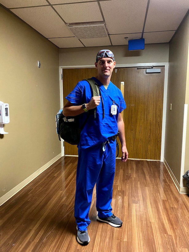 A nurse poses for a photo inside of a hospital.