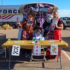 Jeremy Wheeler, left, Reid, center, 11 months, and Schenly Wheeler, 50th Force Support Squadron customer service apprentice, celebrate “tea time” with their Alice in Wonderland-themed trunk Oct. 30, 2020, at Schriever Air Force Base, Colorado during the 50th FSS’s trunk decorating contest. The competition had 10 entries and the top three earned cash prizes of $500, $300 and $200, respectively. (U.S. Space Force photo by Marcus Hill)