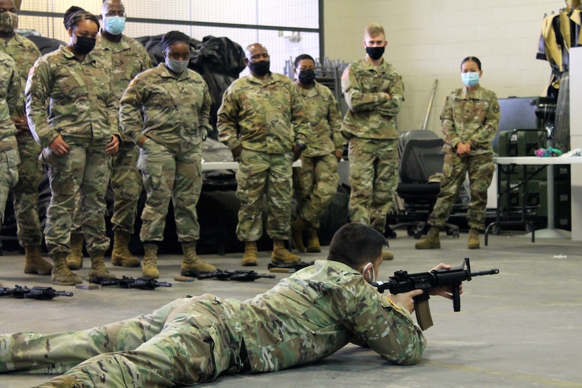 A group of 377th Theater Sustainment Command Soldiers watches a primary marksmanship demonstration during a battle assembly in Belle Chasse, Louisiana October 25, 2020.