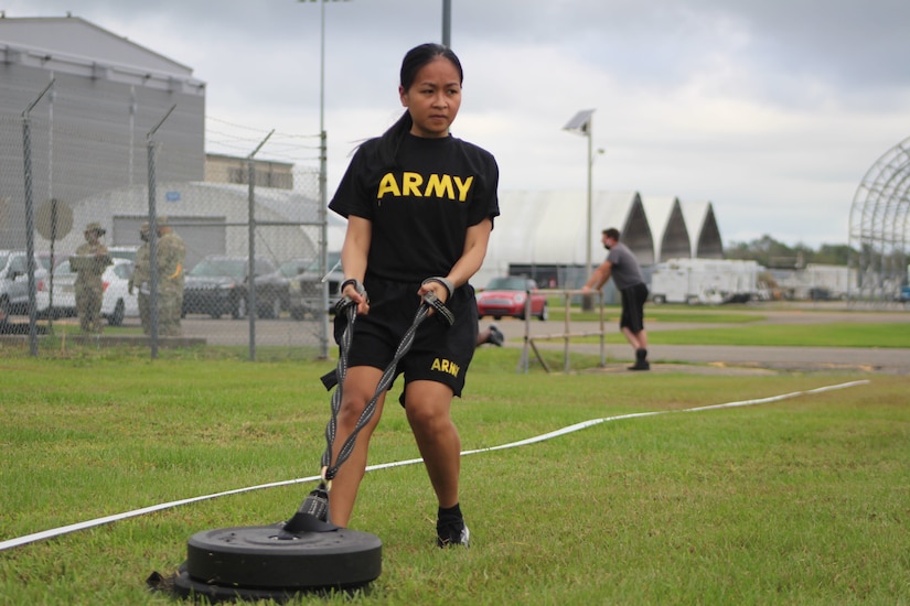 Spc. Ladey Omani, currently serving as a unit supply specialist for the 377th Theater Sustainment Command, pulls a 90-pound weight during training on the Army C