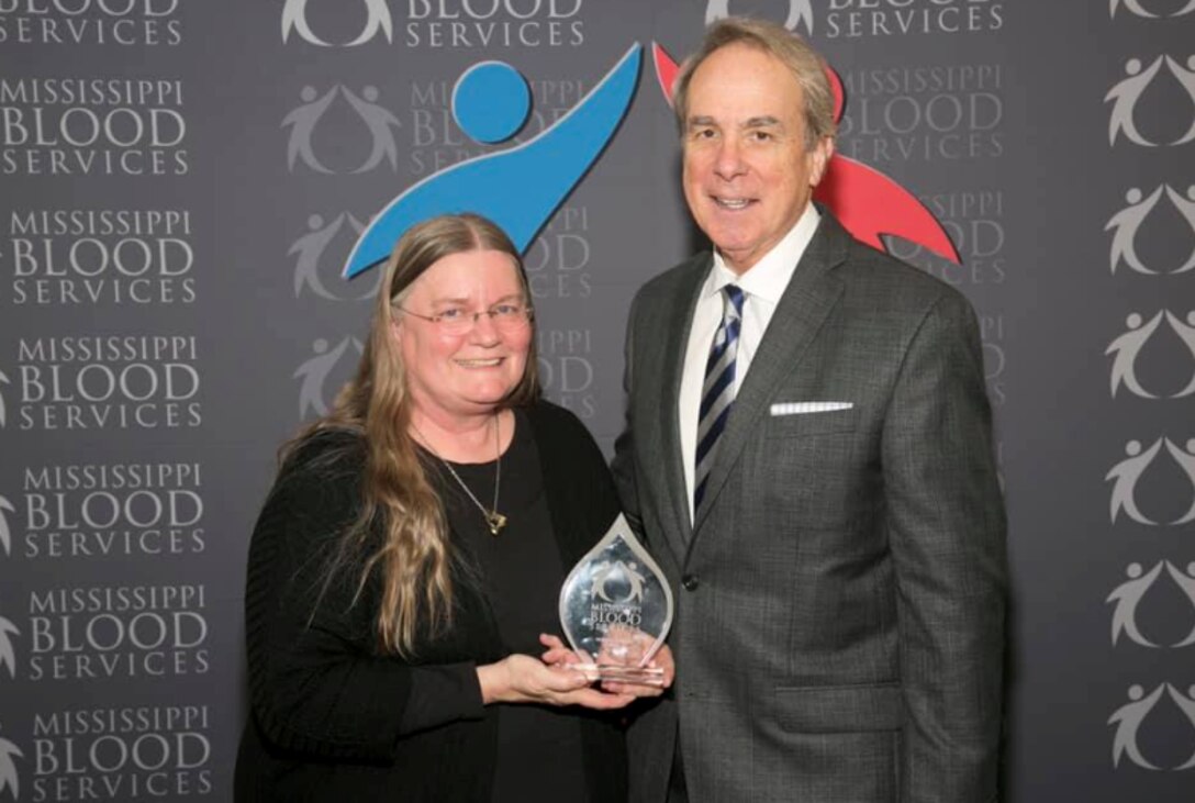 Ruth Osburn, a nurse in Health Services at the U.S. Army Engineer Research and Development Center, poses with David Allen, chief executive officer of Mississippi Blood Services, at a 2018 ceremony where Osburn was recognized as the State of Mississippi Blood Drive Chairperson of the Year for her work in organizing four drives at ERDC.