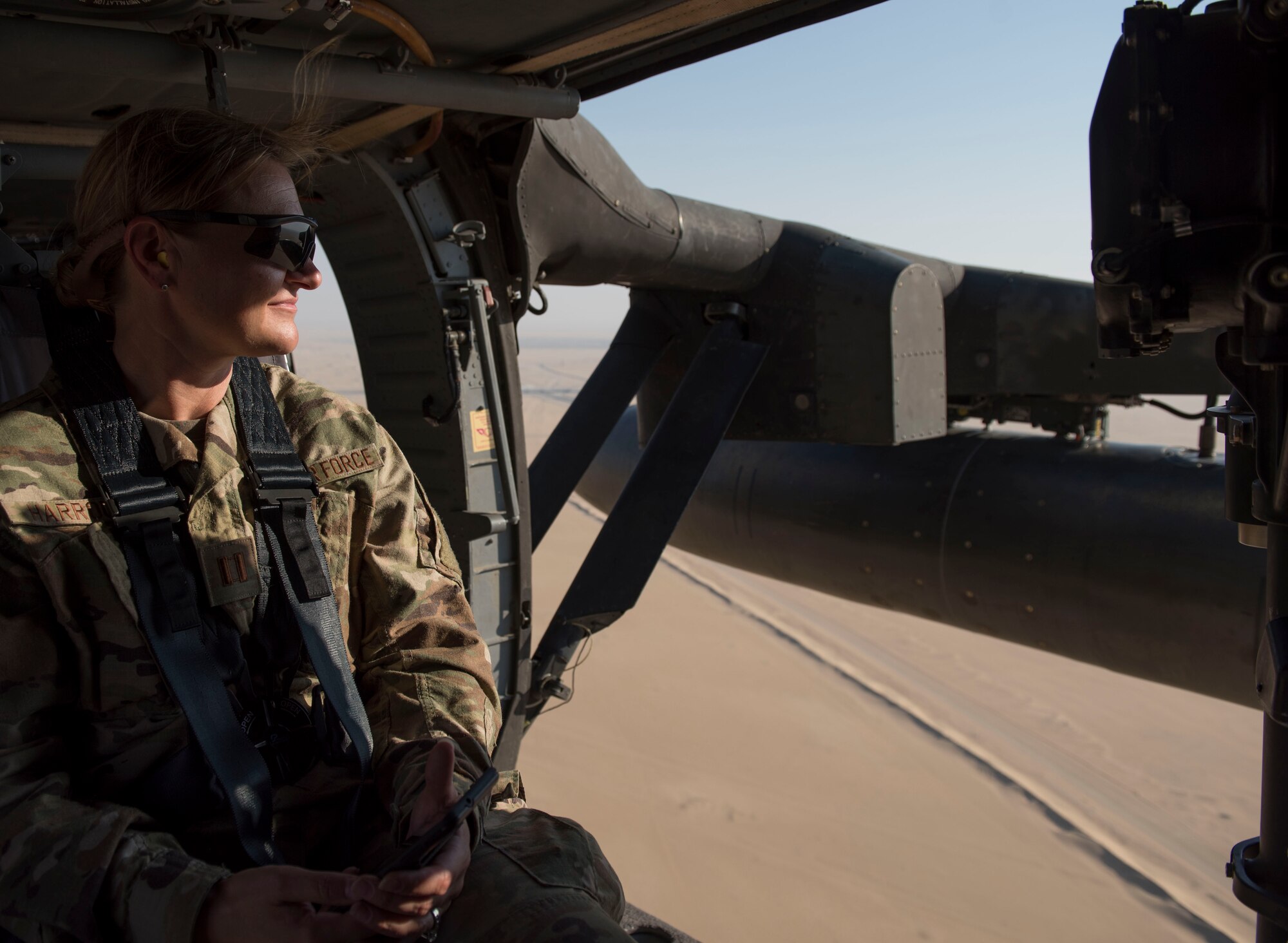 U.S. Air Force Capt. Teresa Harroun, 386th Expeditionary Medical Group chief nurse, looks out of a UH-60 Black Hawk helicopter during a medical evacuation training exercise at Ali Al Salem Air Base, Kuwait, Oct. 27, 2020.