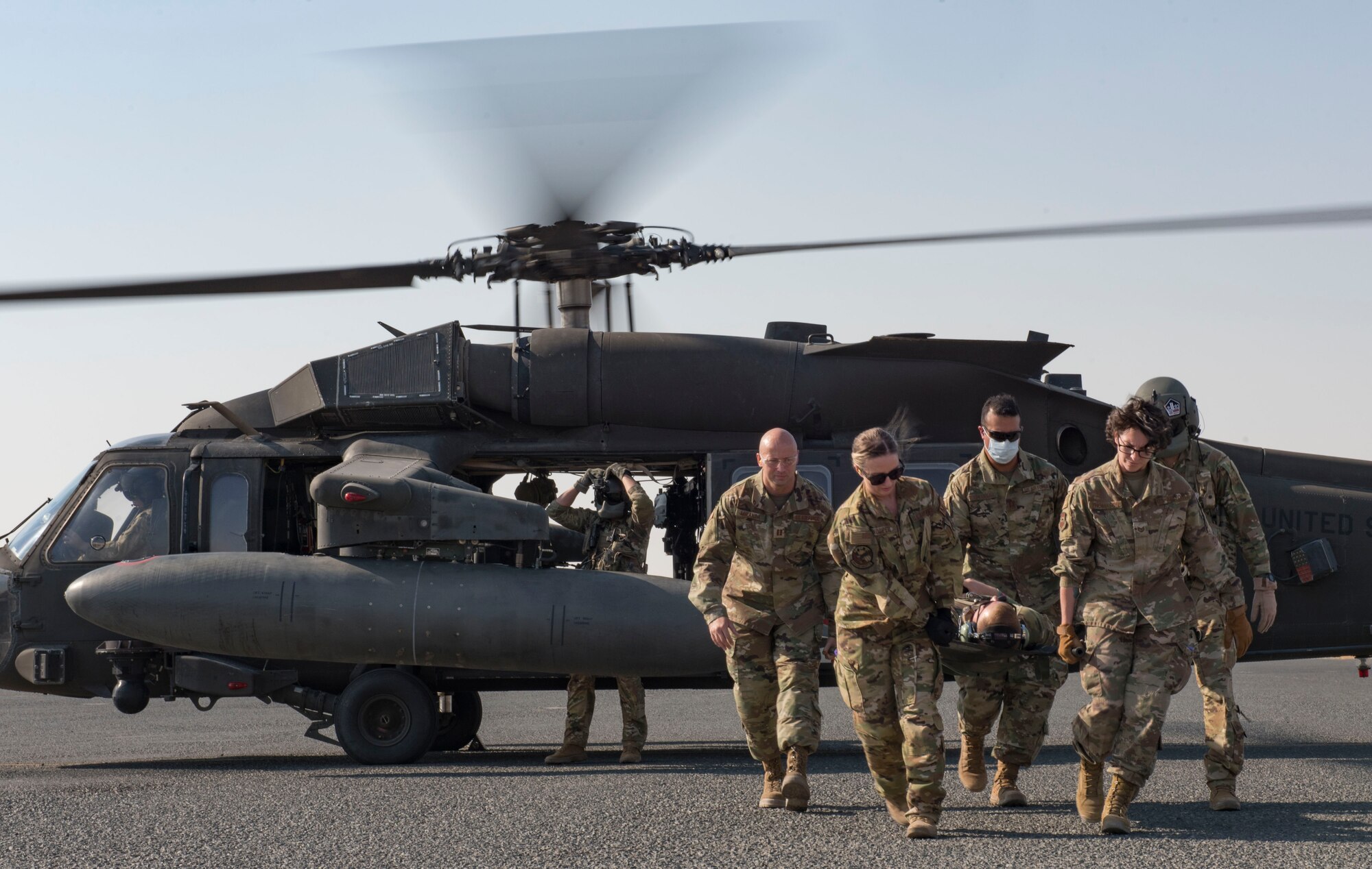 Members assigned to the 386th Expeditionary Medical Group extract a patient from a UH-60 Black Hawk helicopter during a medical evacuation training exercise at Ali Al Salem Air Base, Kuwait, Oct. 27, 2020.