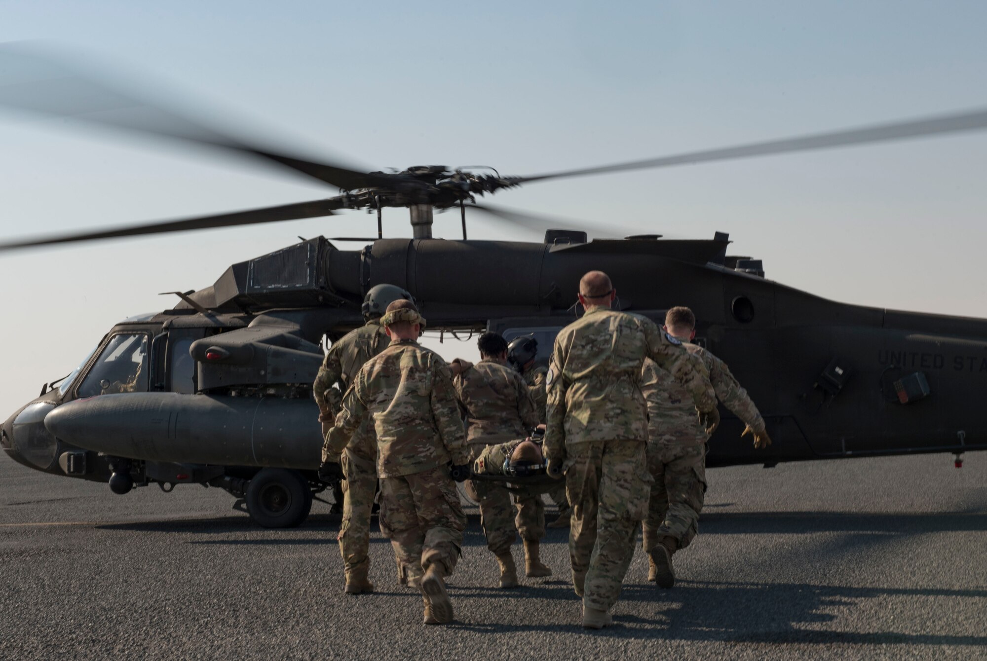 Members assigned to the 386th Expeditionary Medical Group carry a patient to a UH-60 Black Hawk helicopter during a medical evacuation training exercise at Ali Al Salem Air Base, Kuwait, Oct. 27, 2020.