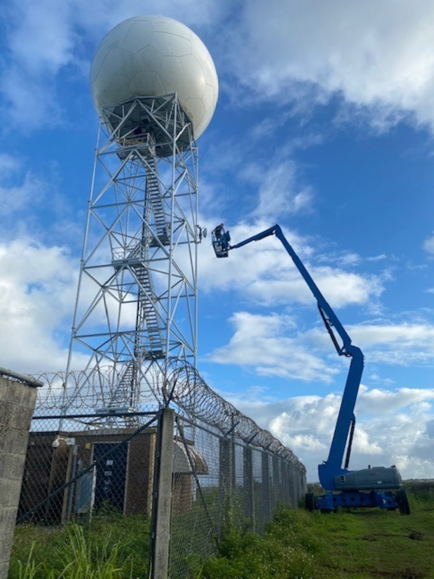 Members of the 36th Operation Support Squadron Radar, Airfield, & Weather Systems use a crane to repair the Next-Generation Radar, March 28, 2020 in Yigo, Guam. The waveguide is a 100-foot tube of pressurized air, which allows signals to pass between the station below and the radar above.  (U.S. Air Force photo by Staff Sgt. Matthew Hawkins)