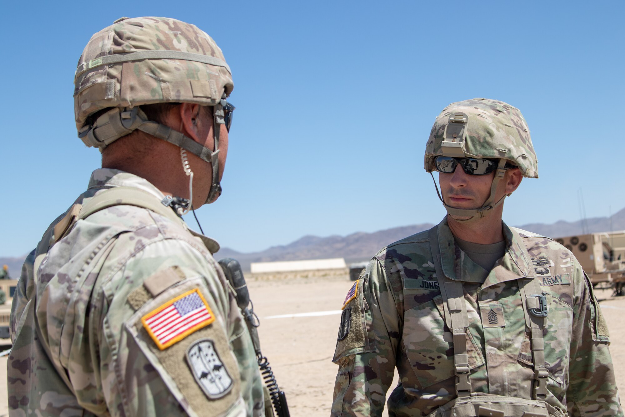 West Virginia Army National Guard (WVNG) State Command Sgt. Maj. James Jones (right) catches up with a 1-150th Cavalry (CAV) Regiment (REG) Soldier while out in the field at the National Training Center in Ft. Irwin, CA during Operation Hickory Sting July 10, 2019. The WVNG's 1-150th CAV REG will deploy in the fall as part of the 30th Armored Brigade Combat Team. (U.S. Army National Guard Photo by Spc. Brianna Lawrence)
