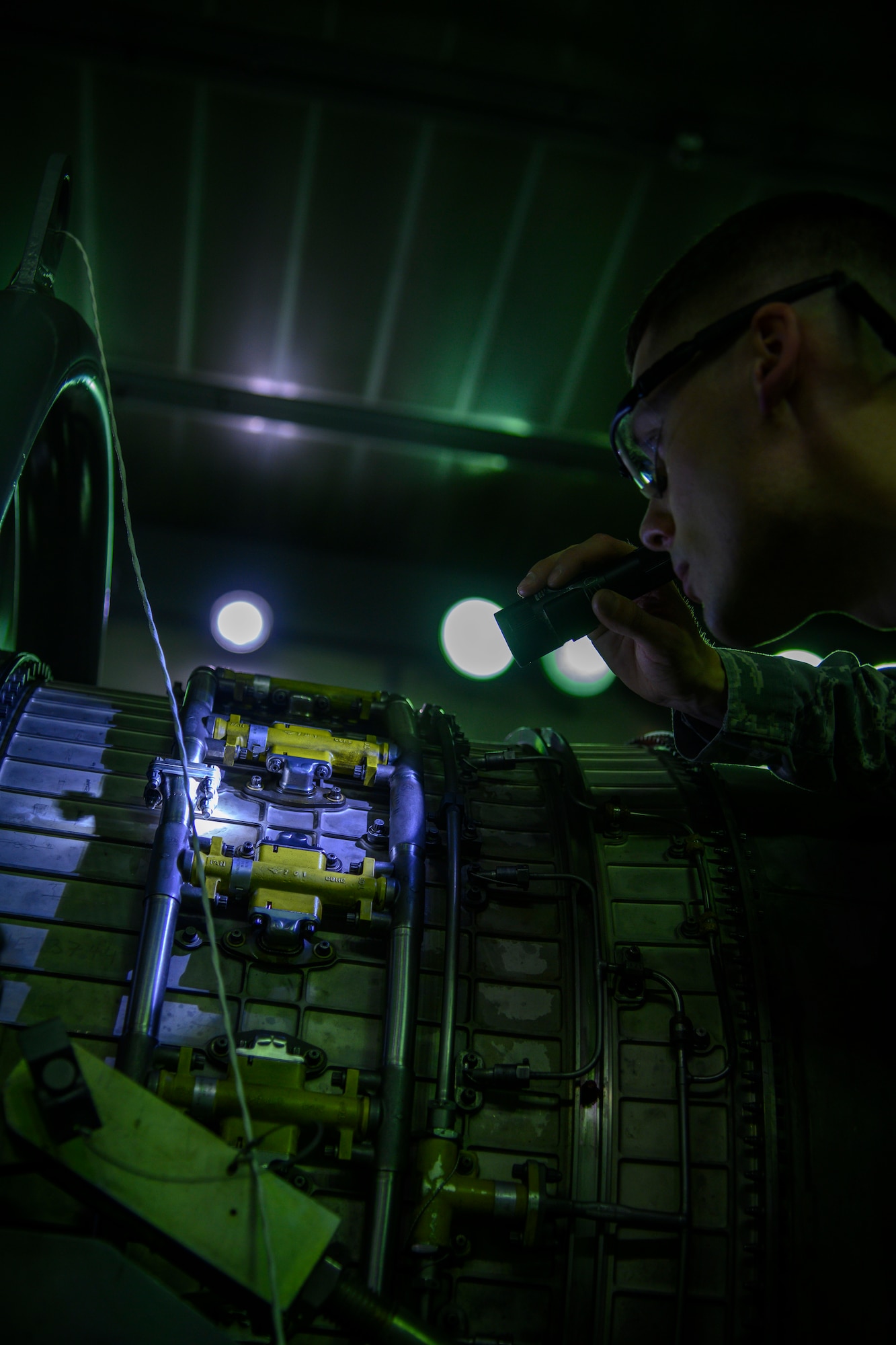 U.S. Air Force Staff Sgt. Casey Jones, a 35th Maintenance Squadron test cell aerospace propulsion journeyman, inspects an engine at Misawa Air Force Base, Japan, Sept. 29, 2020. The 35th MXS aerospace propulsion test cell Airmen are the last line of defense before an engine goes back into an aircraft, ensuring F-16 engine units are safe and ready for flight. (U.S. Air Force photo by Airman 1st Class China M. Shock)