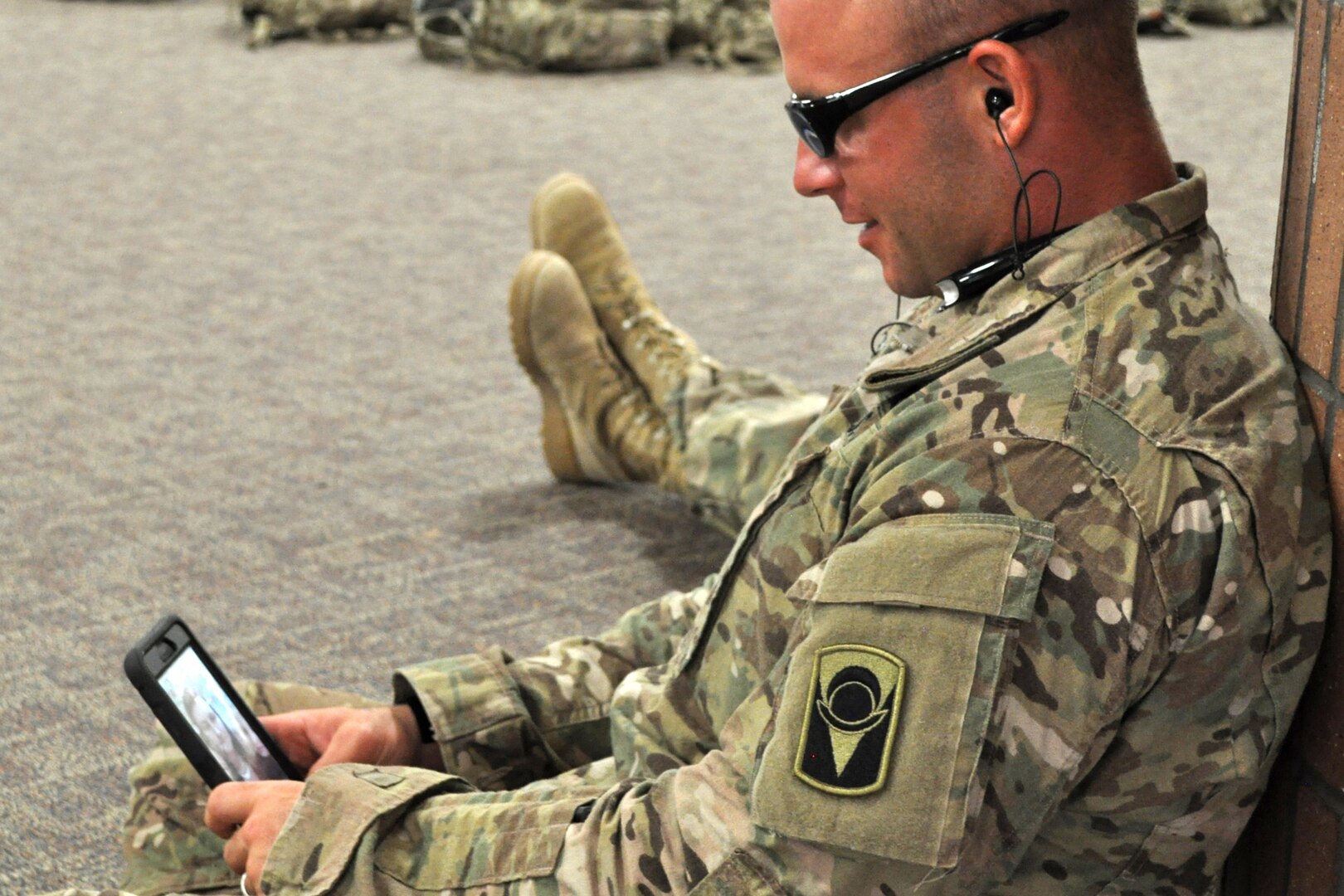 A soldier uses an  app on his cellphone.