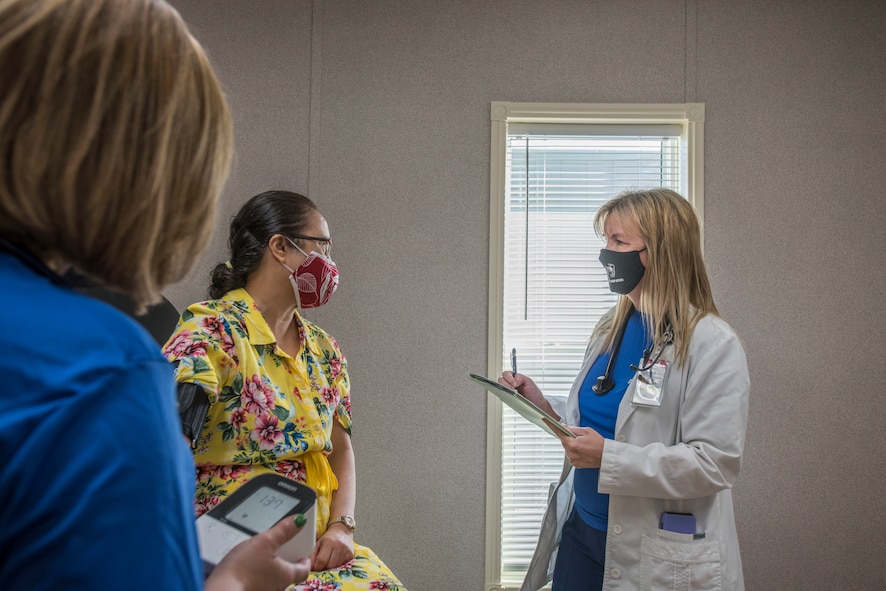 Sally Abare, Operation Warp Speed nurse practitioner, verifies a patient’s health history, Oct. 28, 2020, at Joint Base San Antonio-Lackland, Texas. Patients are evaluated and tested to determine their eligibility to participate in the vaccine clinical study. (U.S. Air Force photo by Airman 1st Class Melody Bordeaux)