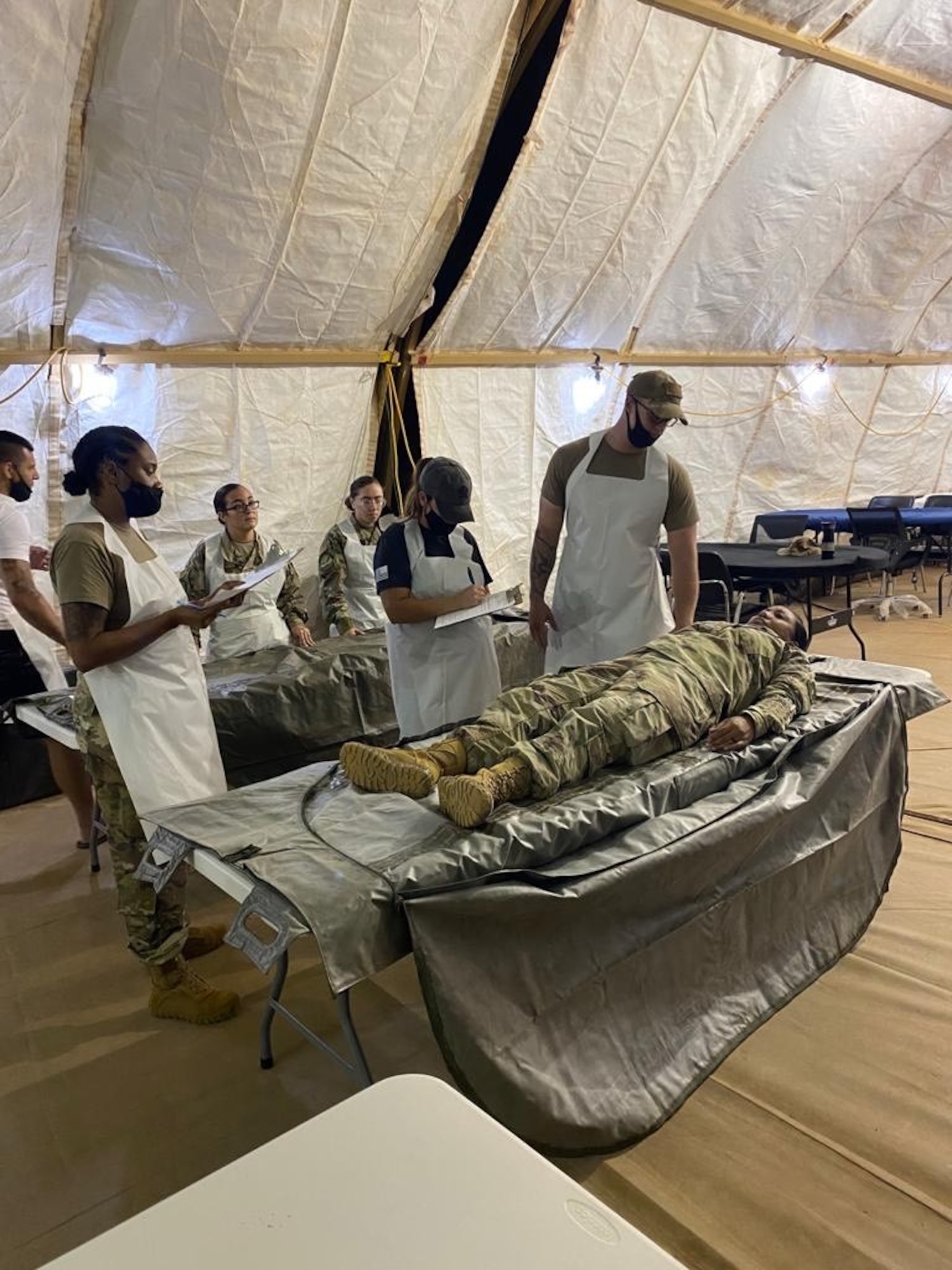 U.S. Airmen from the 768th Expeditionary Air Base Squadron Mortuary Affairs team exercises processing the remains during a short-notice exercise at Nigerian Air Base 101, Niamey, Niger, Oct. 9, 2020.