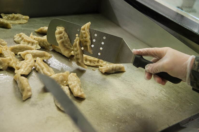 Airman 1st Class Samuel Puzak, 628th Force Support Squadron food services apprentice, prepares bento boxes at the Robert D. Gaylor Dining Facility at Joint Base Charleston, S.C., Nov. 2, 2020. Airmen and civilians who work at the dining facility work as part of a seven to 12 member team and serve meals to approximately 300 personnel during lunch hours. 628th FSS members ensure service members and civilians are fed at Joint Base Charleston, but feeding the force is just one mission that the FSS team is responsible for. The four core areas of services are food service, lodging, readiness, and fitness and sports.