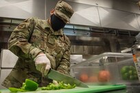 Senior Airman Joshua Cruz, 628th Force Support Squadron dining facility shift leader, cuts and stores vegetables at the Robert D. Gaylor Dining Facility at Joint Base Charleston, S.C., Nov. 2, 2020. Airmen and civilians who work at the dining facility work as part of a seven to 12 member team and serve meals to approximately 300 personnel during lunch hours. 628th FSS members ensure service members and civilians are fed at Joint Base Charleston, but feeding the force is just one mission that the FSS team is responsible for. The four core areas of services are food service, lodging, readiness, and fitness and sports.