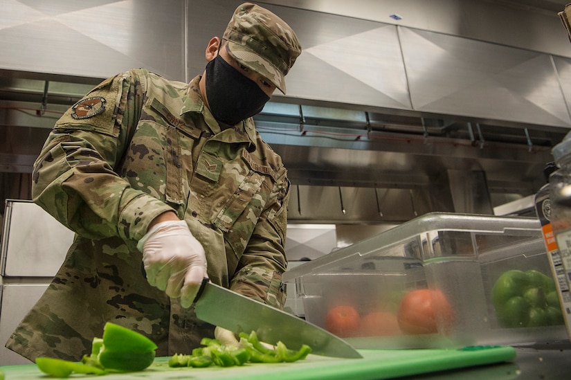 Senior Airman Joshua Cruz, 628th Force Support Squadron dining facility shift leader, cuts and stores vegetables at the Robert D. Gaylor Dining Facility at Joint Base Charleston, S.C., Nov. 2, 2020. Airmen and civilians who work at the dining facility work as part of a seven to 12 member team and serve meals to approximately 300 personnel during lunch hours. 628th FSS members ensure service members and civilians are fed at Joint Base Charleston, but feeding the force is just one mission that the FSS team is responsible for. The four core areas of services are food service, lodging, readiness, and fitness and sports.