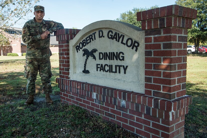 Senior Airman Joshua Cruz, 628th Force Support Squadron dining facility shift leader, stands in front of the Robert D. Gaylor Dining Facility at Joint Base Charleston, S.C., Nov. 2, 2020. Airmen and civilians who work at the dining facility work as part of a seven to 12 member team and serve meals to approximately 300 personnel during lunch hours. 628th FSS members ensure service members and civilians are fed at Joint Base Charleston, but feeding the force is just one mission that the FSS team is responsible for. The four core areas of services are food service, lodging, readiness, and fitness and sports.
