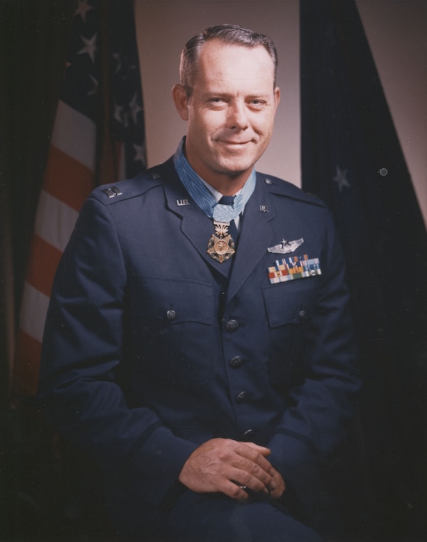 A man in uniform wearing a medal around his neck.