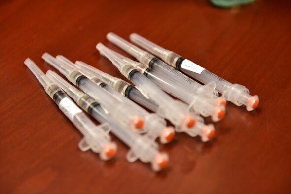 Flu shots sit on a table ready to be dispersed in the Norma Brown Building on Goodfellow Air Force Base, Texas, Nov. 2, 2020. The table was disinfected and masks were worn to ensure proper adherence to Centers for Disease Control and Prevention guidelines. (U.S. Air Force photo by Staff Sgt. Seraiah Wolf)