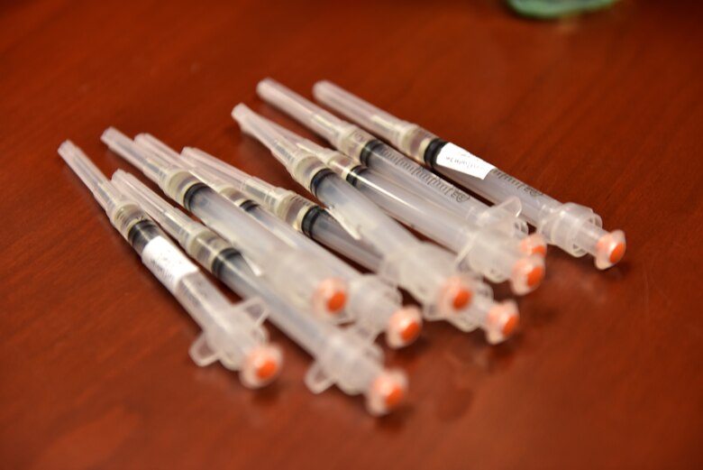 Flu shots sit on a table ready to be dispersed in the Norma Brown Building on Goodfellow Air Force Base, Texas, Nov. 2, 2020. The table was disinfected and masks were worn to ensure proper adherence to Centers for Disease Control and Prevention guidelines. (U.S. Air Force photo by Staff Sgt. Seraiah Wolf)