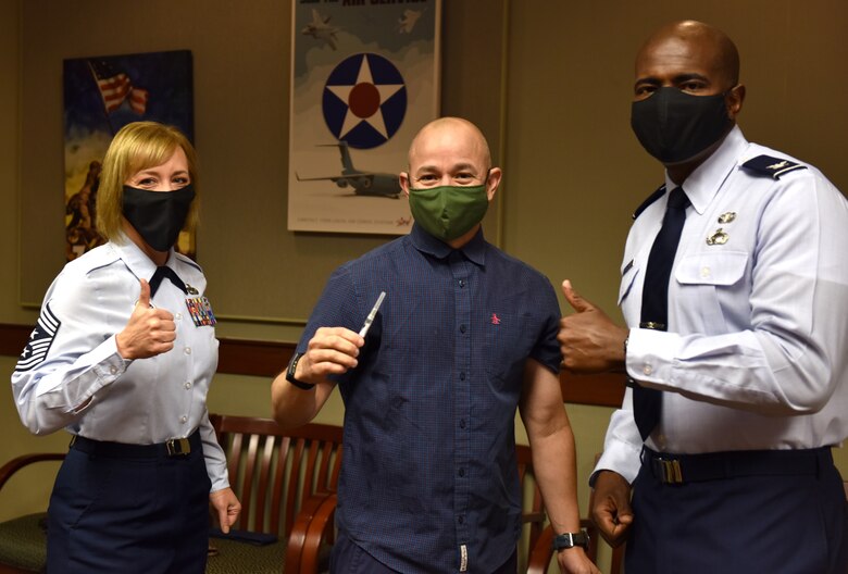 U.S Air Force Chief Master Sgt. Casy Boomershine, 17th Training Wing command chief, Col. Andres Nazario, 17th TRW commander and Col. James Finlayson, 17th TRW vice commander, pose for a picture after Nazario received his flu shot at the Norma Brown Building on Goodfellow Air Force Base, Texas, Nov. 2, 2020. Nazario received his flu vaccine while on leave. (U.S. Air Force photo by Staff Sgt. Seraiah Wolf)