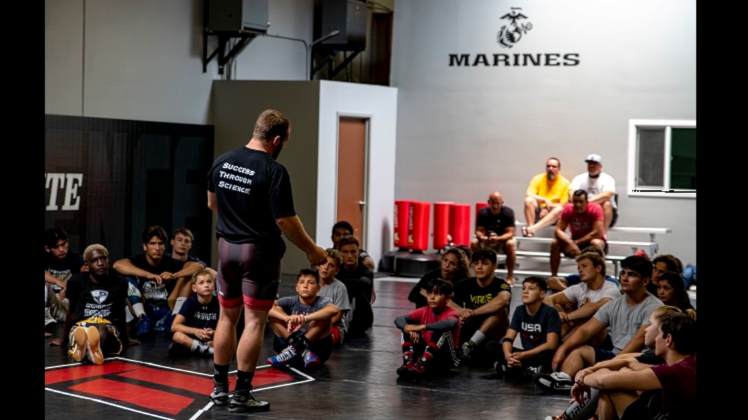 Kyle Snyder, 2016 Olympic gold medalist and 4x world wrestling champion, speaks to participants during a wrestling clinic at The Treigning Lab, in Orange County, Calif. on July 25, 2020. The Treigning Lab hosted a wrestling clinic led by the champion, to teach younger wrestlers new techniques. To safeguard the health of the clinician and registrants, a COVID-19 test was administered to attendees prior to entering the building.