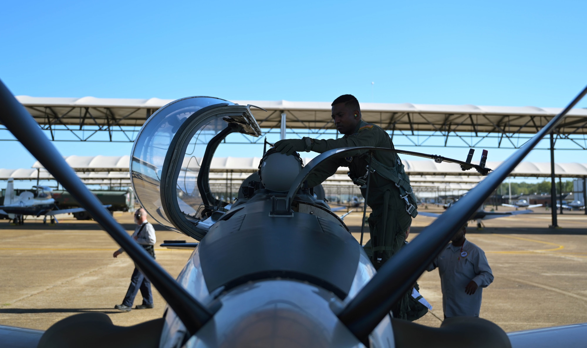 U.S. Air Force 2nd Lt. Clifford Mua, 41st Flying Training Squadron student pilot, places his helmet on the aircraft before stepping inside the cockpit of a T-6 Texan II Nov. 4, 2020, on Columbus Air Force Base Miss. Mua, originally from the Republic of Cameroon, came to the U.S., by winning a diversity visa lottery allowing him to immigrate here on a green card visa before eventually gaining his U.S. citizenship. (U.S. Air Force photo by Senior Airman Jake Jacobsen)