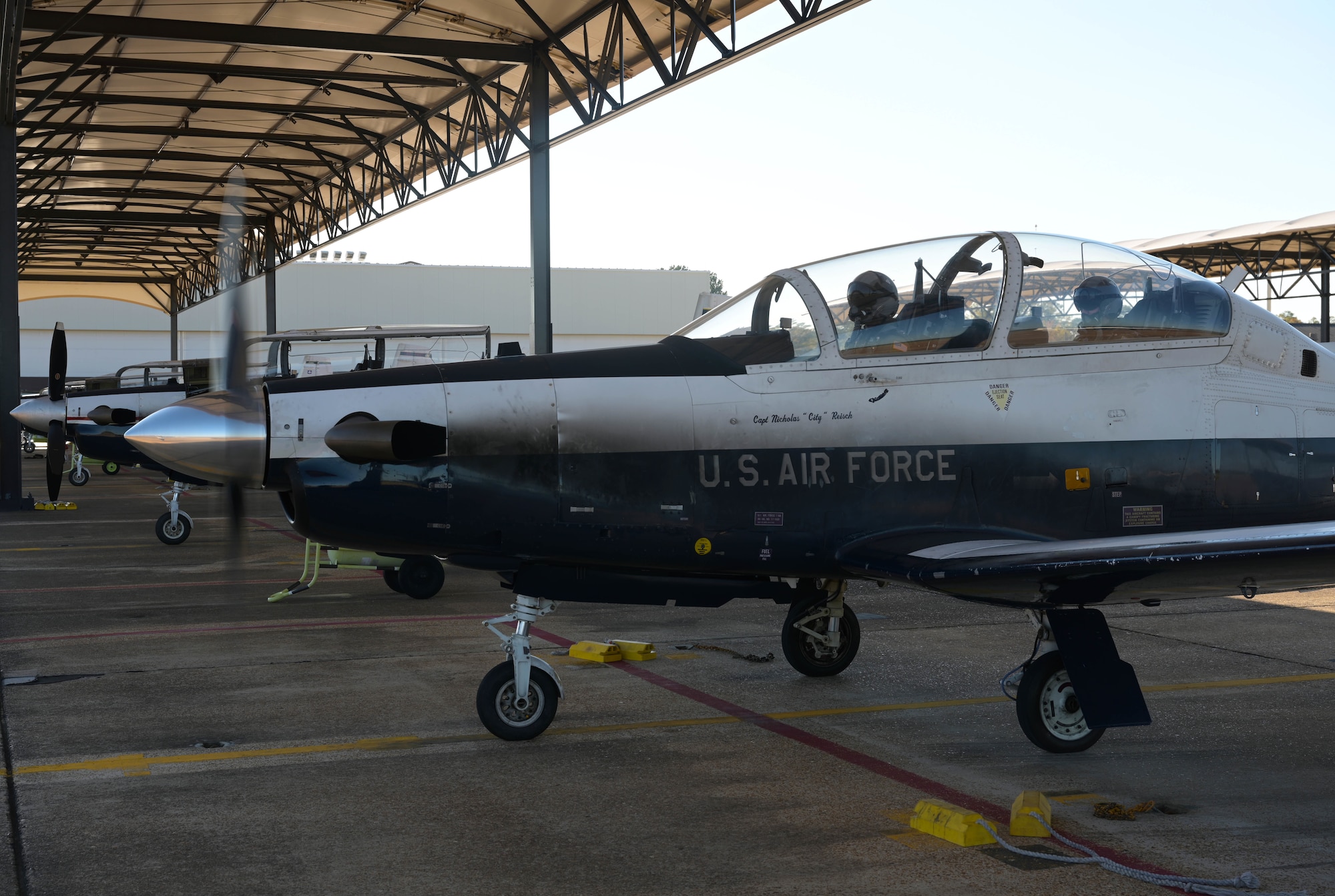 U.S. Air Force 2nd Lt. Clifford Mua (left), 41st Flying Training Squadron student pilot, and Maj. Samuel Berryhill, 41st Flying Training Squadron instructor pilot, taxi in a T-6 Texan II to the runway Nov. 4, 2020, on Columbus Air Force Base Miss. As a Guardsman, Mua is already on a designated track for the KC-135 Stratotanker. Traditionally student pilots are assigned to their airframes the night before graduation. (U.S. Air Force photo by Senior Airman Jake Jacobsen)