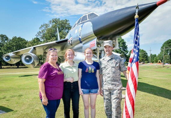 Air Force Reserve Tech. Sgt. Malcom Moe, 96th Aerial Port squadron, poses with his family in front of a static display aircraft after a reenlistment ceremony at Little Rock Air Force Base, Ark., Aug. 3, 2020. (U.S. Air Force Reserve photo by Senior Amn Nathan Byrnes)