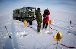 Canadian Armed Forces members set up satellite targets in ice, snow in Resolute Bay, Nunavut