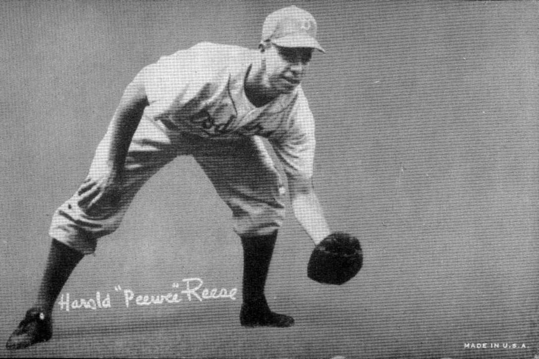 Baseball player holds catchers mitt.