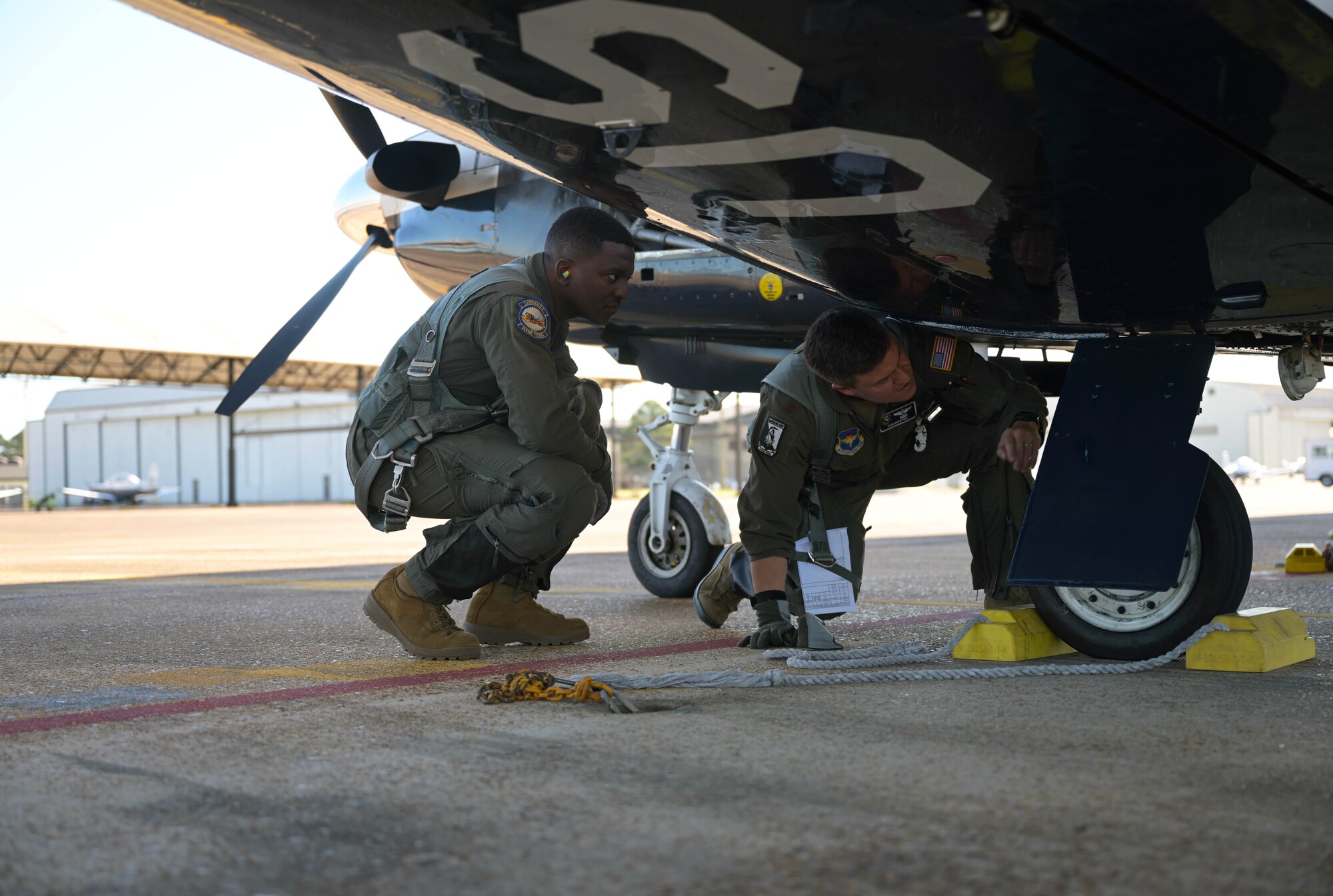 U.S. Air Force Maj. Samuel Berryhill (right), 41st Flying Training Squadron instructor pilot, shows 2nd Lt . Clifford Mua, 41st Flying Training Squadron student pilot, the pre-flight check procedures on the T-6 Texan II Nov. 4, 2020, on Columbus Air Force Base Miss. Instructor pilots learn how to train students at Pilot Instructor Training where they are taught to teach precise maneuvers in the T-6 Texan II, T-1 Jayhawk, or T-38 Talon. (U.S. Air Force photo by Senior Airman Jake Jacobsen)