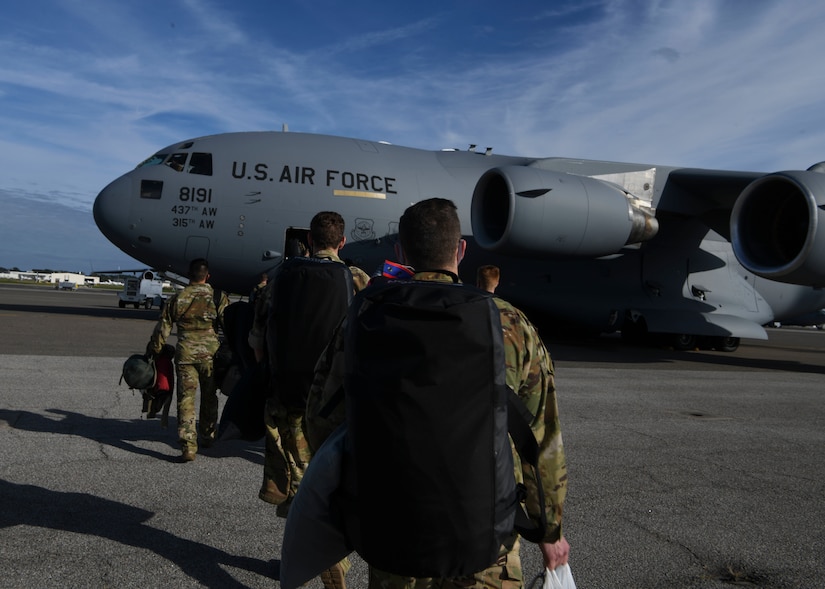 Airmen assigned to the 15th Airlift Squadron step to a C-17 Globemaster III for a deployment swap to Al Udeid Air Base, Qatar, at Joint Base Charleston, S.C. Oct. 28, 2020. Airmen assigned to the 15th AS replaced Airmen assigned to the 16th AS, who were returning home after a 90-day deployment. Both squadrons fly and operate C-17s assigned to the 437th Airlift Wing.