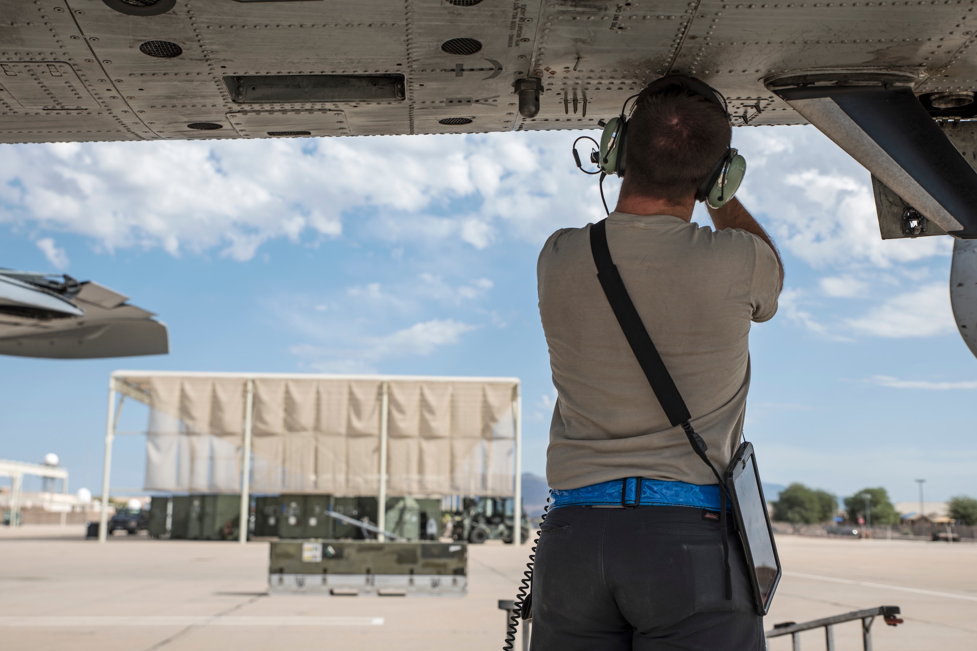 A photo of an Airman doing pre-flight inspections