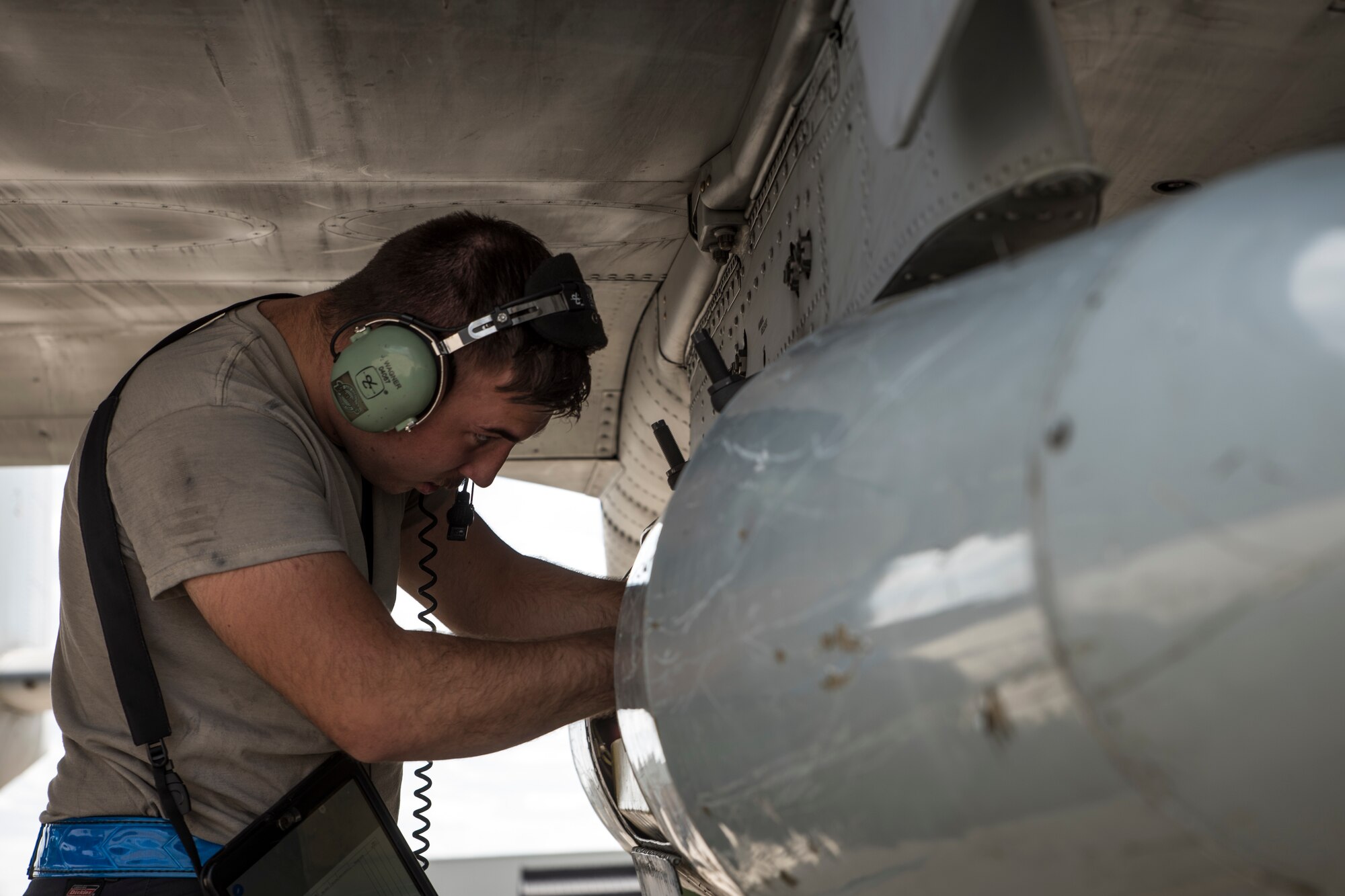 A photo of an Airman doing pre-flight inspections