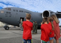 Service members and family members wait to greet Airmen returning from a deployment to Al Udeid Air Base, Qatar, at Joint Base Charleston, S.C., Nov. 1, 2020. Airmen assigned to the 15th Airlift Squadron replaced Airmen assigned to the 16th AS, who were returning home after a 90-day deployment at Al Udeid Air Base, Qatar. Both squadrons fly and operate C-17 Globemaster IIIs assigned to the 437th Airlift Wing.