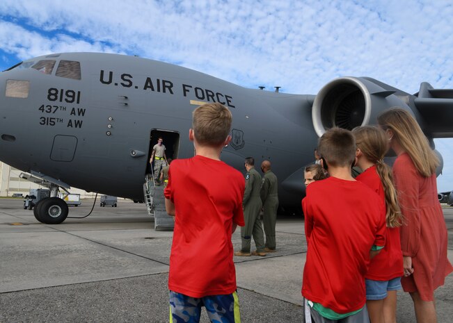 Service members and family members wait to greet Airmen returning from a deployment to Al Udeid Air Base, Qatar, at Joint Base Charleston, S.C., Nov. 1, 2020. Airmen assigned to the 15th Airlift Squadron replaced Airmen assigned to the 16th AS, who were returning home after a 90-day deployment at Al Udeid Air Base, Qatar. Both squadrons fly and operate C-17 Globemaster IIIs assigned to the 437th Airlift Wing.