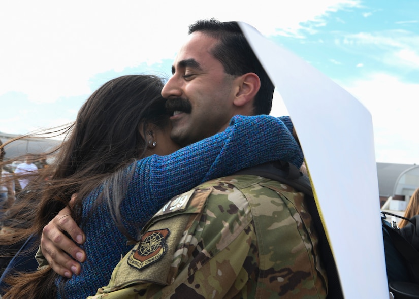 Capt. Abe Iyengar, a pilot assigned to the 16th Airlift Squadron, greets his girlfriend after returning from a deployment to Al Udeid Air Base, Qatar, at Joint Base Charleston, S.C., Nov. 1, 2020. Airmen assigned to the 15th AS replaced Airmen assigned to the 16th AS, who were returning home after a 90-day deployment. Both squadrons fly and operate C-17 Globemaster IIIs assigned to the 437th Airlift Wing.