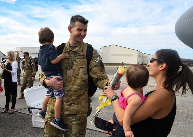 Capt. Josh Bolla, a pilot assigned to the 16th Airlift Squadron, greets his wife and kids after returning from a deployment to Al Udeid Air Base, Qatar, at Joint Base Charleston, S.C., Nov. 1, 2020. Airmen assigned to the 15th AS replaced Airmen assigned to the 16th AS, who were returning home after a 90-day deployment. Both squadrons fly and operate C-17 Globemaster IIIs assigned to the 437th Airlift Wing.