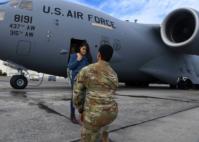 Capt. Abe Iyengar, a pilot assigned to the 16th Airlift Squadron, proposes to his girlfriend after returning from a deployment to Al Udeid Air Base, Qatar, at Joint Base Charleston, S.C., Nov. 1, 2020. Airmen assigned to the 15th AS replaced Airmen assigned to the 16th AS, who were returning home after a 90-day deployment. Both squadrons fly and operate C-17 Globemaster IIIs assigned to the 437th Airlift Wing.