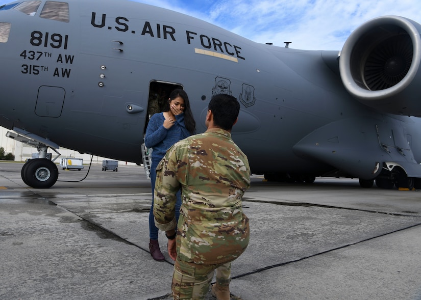 Capt. Abe Iyengar, a pilot assigned to the 16th Airlift Squadron, proposes to his girlfriend after returning from a deployment to Al Udeid Air Base, Qatar, at Joint Base Charleston, S.C., Nov. 1, 2020. Airmen assigned to the 15th AS replaced Airmen assigned to the 16th AS, who were returning home after a 90-day deployment. Both squadrons fly and operate C-17 Globemaster IIIs assigned to the 437th Airlift Wing.