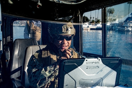 Chief Boatswain�s Mate Ken Dequena, from Iloilo, Philippines relays instruction to his team aboard a Sea Ark 34-foot patrol boat during an outbound transit in Alamitos Bay, Long Beach, California