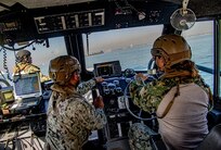 Lt. Cmdr. Trisha Kelly, chief staff officer and executive officer of Maritime Expeditionary Security Squadron (MSRON) 11, operates a Sea Ark 34-foot patrol boat under instruction from Chief Boatswain�s Mate Ken Dequena, patrol lead of MSRON 11