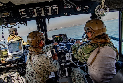 Lt. Cmdr. Trisha Kelly, chief staff officer and executive officer of Maritime Expeditionary Security Squadron (MSRON) 11, operates a Sea Ark 34-foot patrol boat under instruction from Chief Boatswain�s Mate Ken Dequena, patrol lead of MSRON 11