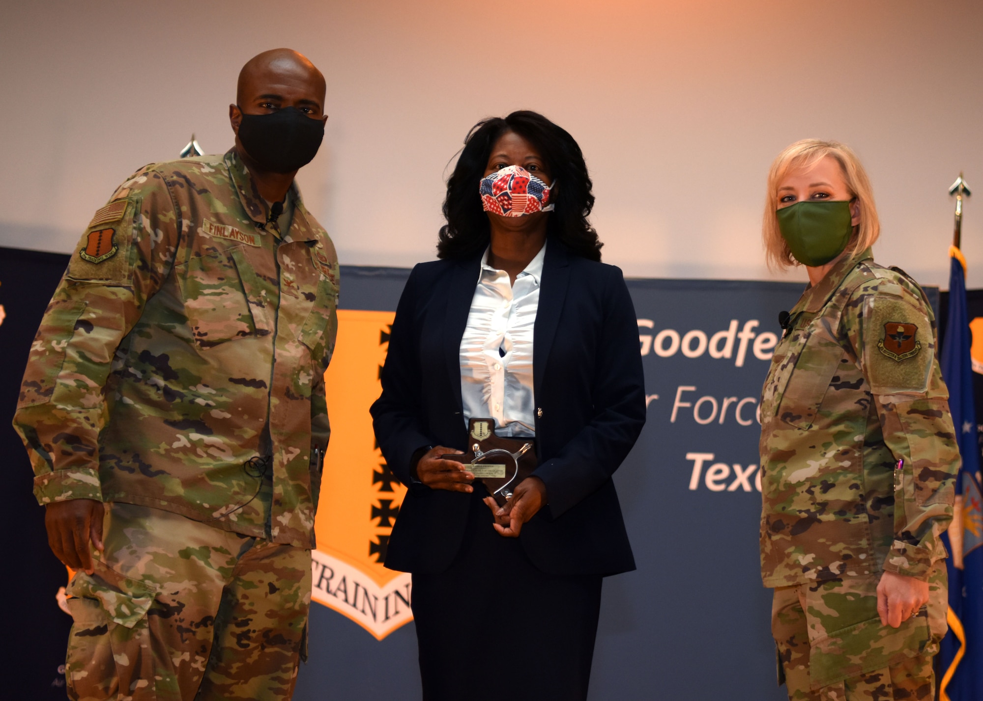 17th Mission Support Group Director of Business Operations, Andrea Jackson, is presented the Civilian Category III Supervisory of the Quarter award by U.S. Air Force Col. James Finlayson, 17th Training Wing vice commander, and Chief Master Sergeant Casy Boomershine, 17th TRW command chief, during the awards ceremony for the third quarter at the Base Theater on Goodfellow Air Force Base, Texas, Oct. 29, 2020. Top performing nominees were chosen by the wing to receive the awards. (U.S. Air Force photo by Airman 1st Class Ethan Sherwood)