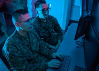 Marines with Marine Corps Forces Cyberspace Command pose for photos in cyber operations room at Lasswell Hall aboard Fort Meade, Maryland, Feb. 5, 2020. MARFORCYBER Marines conduct offensive and defensive cyber operations in support of United States Cyber Command and operate, secure and defend the Marine Corps Enterprise Network.