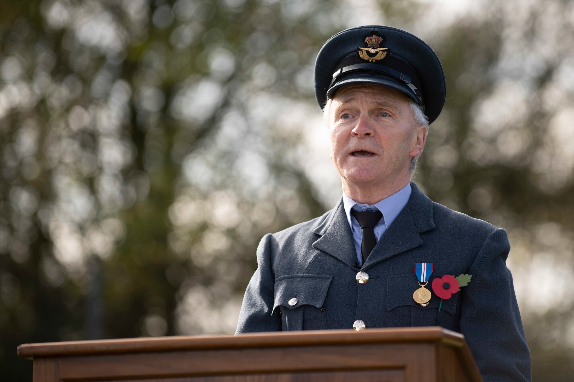 Royal Air Force Sqn. Ldr. Clive Wood, RAF Alconbury and RAF Molesworth RAF commander, reads an excerpt from the poem “For the Fallen,” by Robert Laurence Binyon, during a Remembrance Sunday ceremony near the 303rd Bombardment Group monument at RAF Molesworth, England, Nov. 3, 2020. Remembrance Sunday is commemorated the second Sunday every November to honor the service and sacrifice of Armed Forces, British and Commonwealth veterans, as well as the Allies that fought alongside them in the two World Wars and later conflicts. (U.S. Air Force photo by Senior Airman Jennifer Zima)
